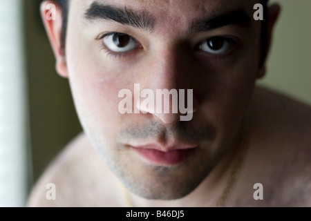 A portrait of a young man with a serious or concerned look on his face Stock Photo