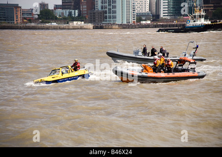 Dutton Mariner amphibian car on the Mersey river, Liverpool at the start of the Tall Ships Race Parade with  a lifeboat Stock Photo