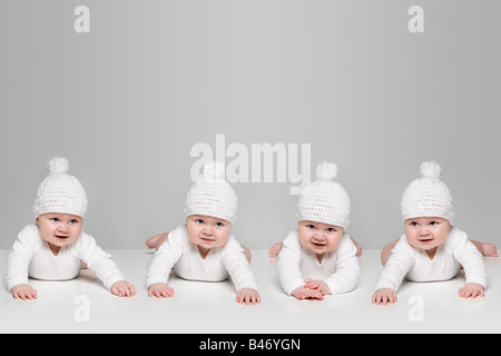 Babies in bobble hats Stock Photo