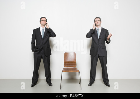 Businessman with cellphones Stock Photo