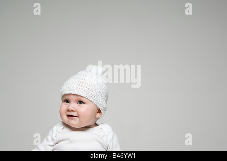 Baby in a bobble hat Stock Photo