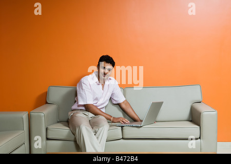 Indian man using a laptop computer Stock Photo