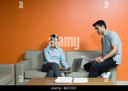 Two colleagues using a laptop computer Stock Photo