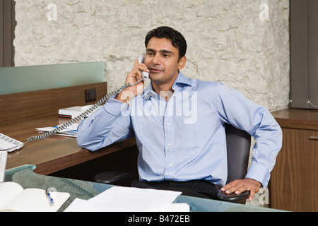 Indian businessman using the telephone Stock Photo