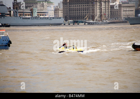 Dutton Mariner amphibian car on the Mersey river, Liverpool at the start of the Tall Ships Race Parade with RFA Lyme Bay behind Stock Photo