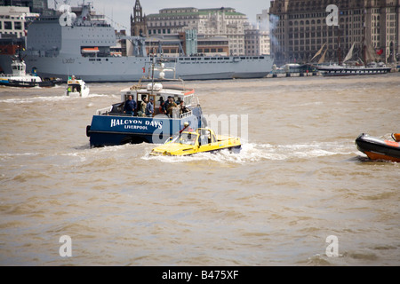 Dutton Mariner amphibian car on the Mersey river, Liverpool at the start of the Tall Ships Race Parade with RFA Lyme Bay behind Stock Photo