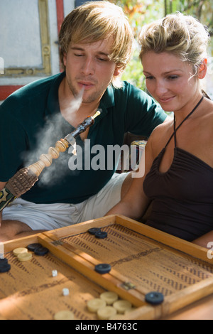 Couple with hookah and backgammon Stock Photo