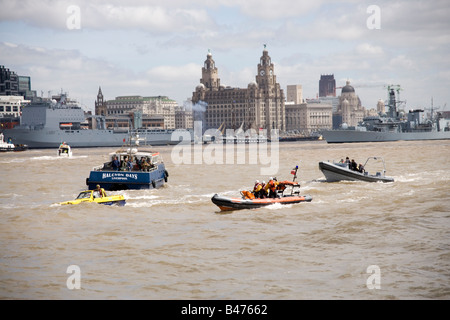 Dutton Mariner amphibian car on the Mersey river, Liverpool at the start of the Tall Ships Race Parade with RFA Lyme Bay behind Stock Photo