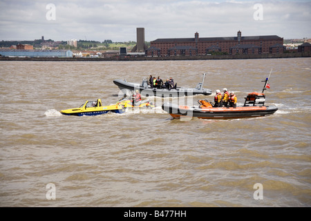 Dutton Mariner amphibian car on the Mersey river, Liverpool at the start of the Tall Ships Race Parade with  a lifeboat Stock Photo