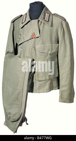 A fatigue uniform, for non-commissioned officers in the special cut for armoured units. Unlined blouse of light, field grey cotton. Army cut with a pocket on the left side of the chest and a belt opening. Synthetic resin buttons, BeVo chest eagle. Unit collar flashes on drill backing with bordeaux red piping. Slip on shoulder boards with field grey braid. Iron Cross button hole ribbon. Medal loops for pinned decorations. Trousers of identical material with artificial silk and linen lining. Integral belt, side pockets, oversize pockets in front with flaps. Off-s, Stock Photo