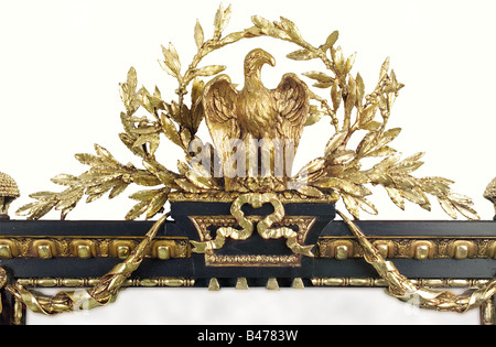 A splendid mirror, France, 2nd Empire, 1852 - 1870. Richly carved and plaster decorated frame, gilded in places. At the top an imperial eagle in a laurel wreath with laurel garlands below. Floral decoration on the sides, and on the bottom is an inscription panel with the imperial monogram 'N'. Plaster decoration is cracked. New gilding on the obverse side, covered with clear coat in places. Remnants of the old gilding are still visible. Has a new mirror glass. 93 x 121 cm. Frame Dimensions: 164 x 209 cm. Impressive, decorative object from the epoch of Napoleon , Stock Photo