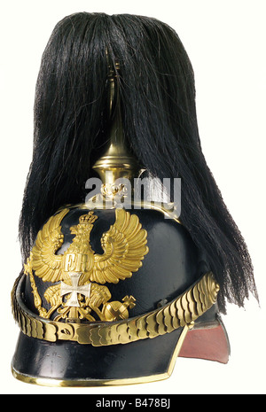 Prussia: A helmet of 1860 pattern for reserve officers, of the infantry. A well-preserved leather skull, with two assymetrically placed holes underneath the plate, and a slight dent on the rear peak. Gilt brass mountings, a plume holder with a black parade horsehair plume, and a frosted gilt plate overlaid with a reserve cross. Flat chinscales, and an officers' pattern state cockade on the right side. Red leather liner with slight traces of wear. Size 56. historic, historical, 19th century, object, objects, stills, clipping, clippings, cut out, cut-out, cut-out,