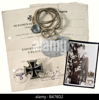 A black Panzer Troop uniform, orders and citations for Feldwebel Herbert Fichter of the 1st Panzer Regiment. Enlisted man's black wool field cap, grey green cotton lining with maker's stamp and size stamp '58', woven BeVo insignia, aluminum oak leaf on the side for the members of the 1st Panzer Division. Black wool panzer jacket, bro historic, historical, people, 1930s, 1930s, 20th century, armoured corps, armored corps, tank force, tank forces, branch of service, branches of service, armed service, armed services, military, militaria, utensil, piece of equipme, Stock Photo