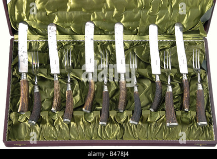 Karl Wolff - a hunting table setting., Iron, nickel-silver, staghorn. Six knives and six forks. The grip caps are engraved with the 'Wolfsangel', Karl Wolf's personal mark. The supplier's inscription, 'Fr. Widmann München' is on the knife blades. The case is lined with green silk and bears the company label 'F. Widmann & Sohn - k.b Hoflieferantan -München - Karlsthor' (F. Widmann & Son - Purveyors to the Royal Bavarian Court -Munich - Carls Gate). Knife lengths ca. 25.5 cm. Fork lengths ca. 21.5 cm. There is also a photocopy of an illustration of his SS-Leader', Stock Photo