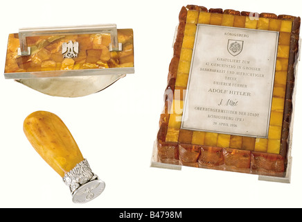 Adolf Hitler - an amber writing desk set., A gift from the City of Königsberg on Hitler's 47th Birthday on 20 April 1936. Silver, amber, and wood, with a silver-plated figure of Atlas. The individual pieces composing the set are: a) a large paperweight with an engraved silver dedication plaque, 'Königsberg gratuliert zum 47. Geburtstag in grosser Dankbarkeit und aufrichtiger Treue unserem Führer Adolf Hitler - H. Mill - Oberbürgermeister der Stadt Königsberg (Pr.) 20. April 1936'. (Königsberg congratulates our Führer Adolf Hitler on his 47th Birthday in Sincere, Stock Photo