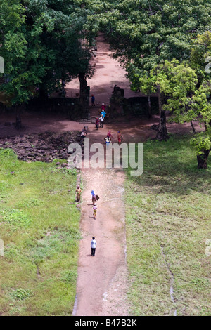 Cambodian Khmer workers walking down a dirt path viewed from above, Prasat Thom, Koh Ker, Cambodia Stock Photo