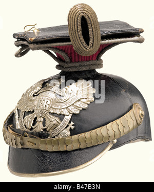 A czapka for officers, of the 2. Hanoverian Uhlan Regiment No. 14 A four piece, black lacquered leather skull (lightly warped) with silver brim edging and emblem with the scroll 'Waterloo Peninsula Garzia Hernandez', cambered, golden metal chin scales with pin rosettes. Officer cockade. Brown sweatband with greenish, ribbed silk lining. Complete with the crimson parade cover and officer's field badge. historic, historical, 19th century, object, objects, stills, clipping, clippings, cut out, cut-out, cut-outs, helmet, helmets, headpiece, headpieces, utensil, pie, Stock Photo