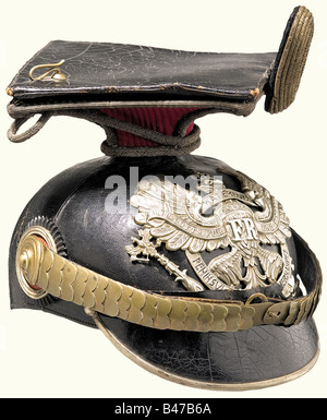 A czapka for officers, of the 2. Hanoverian Uhlan Regiment No. 14 A four piece, black lacquered leather skull (lightly warped) with silver brim edging and emblem with the scroll 'Waterloo Peninsula Garzia Hernandez', cambered, golden metal chin scales with pin rosettes. Officer cockade. Brown sweatband with greenish, ribbed silk lining. Complete with the crimson parade cover and officer's field badge. historic, historical, 19th century, uniform, uniforms, piece of clothing, clothes, outfit, outfits, helmet, helmets, cap, caps, headpiece, headpieces, object, obj, Stock Photo