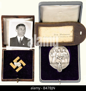 Fritz Wiedemann, Hitler's personal adjutant., Decorations, officer's sabre and dagger NSDAP gold party badge in 30 mm version. Gold-plated, hollow backed, enamelled. Reverse 'Ges. Gesch.' and the engraving 'A.H. 30.1.1938'. Very well preserved, pin catch slightly bent. In addition passport photo of Wiedemann in civilian clothes with party badge, on the back of the picture the note 'Presse Illustrationen Hoffmann, Berlin SW 58, Nachdruck verboten'. Badge commemorating 'Tag der Arbeit 1935' in solid silver edition, stamped on the reverse 'Deschler München' and 'S, Stock Photo