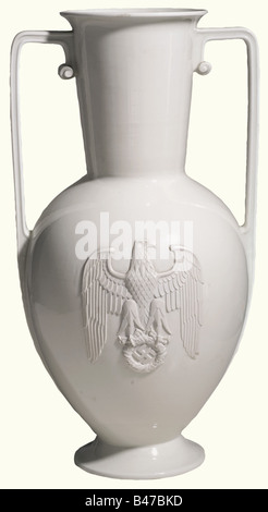 A large vase with handles, Allach Porcelain Manufacture Special model with the party eagle in relief. White glazed porcelain, the detailed and finely modelled eagle unglazed. The manufacturer's mark 'SS Allach' in underglaze green on the bottom. Height 55 cm. Undamaged, the bottom with small manufacturing defect. Only very little is known about this extremely rare special model, the form of which corresponds to the porcelain vase no. 506, that could be ordered with or without handles. Today, it is called 'the Reichs Chancellery Vase' with some justification, as, Stock Photo