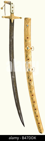 Saddam Hussein - a presentation shamshir to Lajos Czinege, Hungarian Minister of Defence in the 1960s. Curved blade with two fullers, one behind the other, and a groove on each side. Floral ornamentation on the ricasso and an Arabic inscription on the blade. Gold inlays worn by polishing. Gilded base metal hilt. Bone grip scales with wire windings indicated. Gilded scabbard with relief ornamentation and inset decorative gems. Two movable suspension rings. Length 100 cm. In the presentation case, covered and lined with red velvet. historic, historical 20th centu, Stock Photo