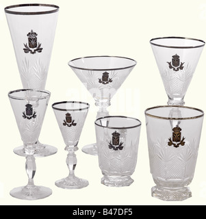 Serbia - a large collection of glassware., 51 pieces of dinner and after dinner glassware from the Royal House of Obrenovic. Blown crystal glass, cut, with silver rim. Engraved and silver-plated royal coat of arms. Seven liqueur glasses, height 13 cm. Four brandy glasses, height 10.5 cm. Six cocktail glasses, height 13.5 cm. Six sherry glasses, height 16.5 cm. Six champagne flutes, height 21 cm. Eight punch mugs with handle, height 8.5 cm. Two water glasses, height 11 cm. Six dessert dishes, height 7.5 cm. Two large dishes, diameter 15.5 cm. A large pastry dish, Stock Photo