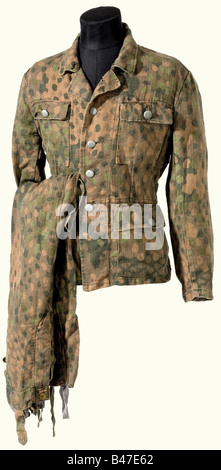 A model 43/44 camouflage suit., The jacket, made of cotton drill is stamped on one side with dot pattern. Bluish artificial silk reinforcements and field dressing packs, quartermaster's stamp, metal buttons. Long trousers of the identical material, pockets and reinforcements of sand coloured linen. Bluish artificial silk lining with a barely legible quartermaster's stamp. The ankle closure with draw strings. Brown, artificial resin buttons (one missing). historic, historical, 1930s, 20th century, Waffen-SS, armed division of the SS, armed service, armed service, Stock Photo