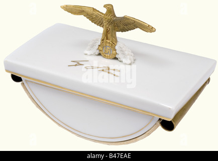 An ink blotter, with national eagle emblem and writing 'Adolf Hitler'. Sheets of blotting paper with traces of ink from Hitler's signature(?). On the back Allach stamp and 'B.v.A.' for Benno von Arent. Height 9 cm, width 13 cm. This ink blotter was allegedly a birthday present from the Allach manufacture for Hitler's 50th birthday. It is said to have belonged to a five-piece porcelain desk set, of which the other parts did not survive the war. Benno von Arent, designer of theatre sets and festival architecture, for example the setting for Mussolini's visit to M, Stock Photo