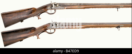 A pair of percussion shotguns, from the armoury of Grand Duke Leopold II of Austria (1797 - 1870). Vienna, circa 1830. Blued octagonal barrels with smooth bores in 15 mm calibre. One of them is stamped 'K:Hollitzer in Wien' on the breech, the second is engraved 'W. Maschek in Wien'. The numbers '4' and '9' respectively are engraved on the tangs. Converted locks with engraved decoration, both inscribed 'Ainsidl in Wien'. Silver escutcheons bear the crowned cipher 'L'. Walnut full stocks with wooden trigger guard and engraved iron furniture. Wooden ramrods with l, Stock Photo
