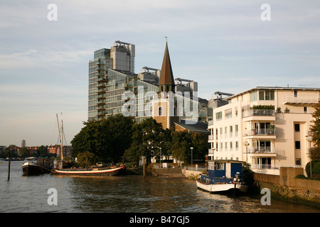 St Mary church in front of the Montrevetro Building on the banks of the River Thames, Battersea, London Stock Photo