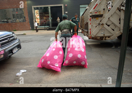 Colorful pink polka dot plastic trash bags are collected in the Meatpacking district in New York Stock Photo