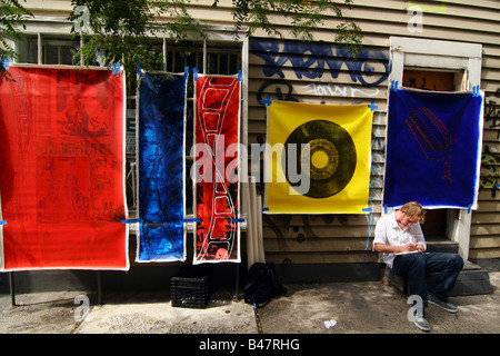 An artist sells his paintings on the street, SOHO, New York City. Stock Photo