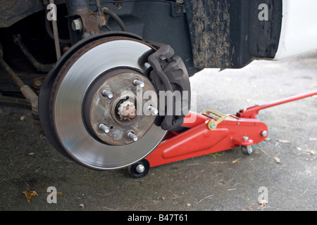 Closeup detail of the wheel assembly on a modern automobile The rim is removed showing the front rotor and caliper Stock Photo