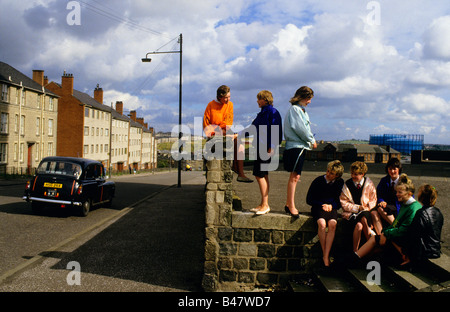 Girls gather on a street corner to chat after school, Glasgow Stock Photo