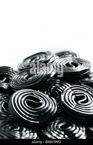 Rolls of tasty liquorice candy rolls isolated on white Stock Photo