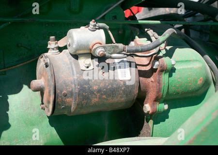 Electric starter on engine of farm tractor Stock Photo