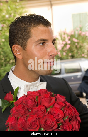 Italian man getting married in Italy holding boquet of roses Stock Photo