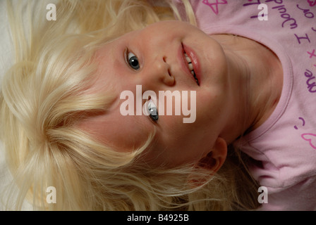 Stock photo of a portrait of a blond haried blue eyed three year old child Stock Photo