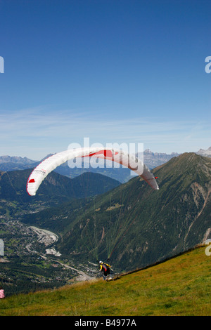 Paragliders launch from the Plan de l'Aiguille into the Chamonix valley in the French Alps Stock Photo
