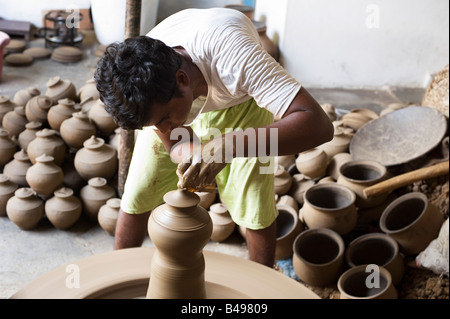 Traditional village Indian potters livelihood, throwing pots out of one lump of . Puttaparthi, Andhra Pradesh, India Stock Photo