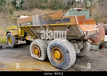 An abandoned Volvo BM A20 dump truck left to rust in a forgotten corner of a quarry Stock Photo