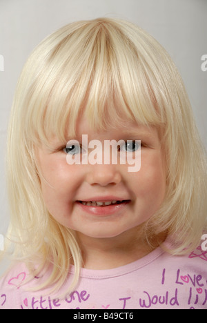 Stock photo of a portrait of a blond haried blue eyed three year old child Stock Photo