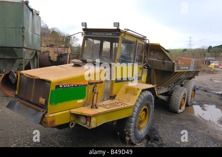 An abandoned Volvo BM A20 dump truck left to rust in a forgotten corner of a quarry Stock Photo