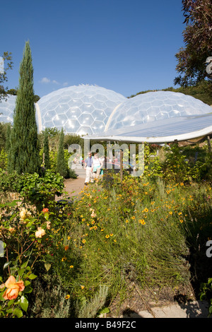 Visitors walking around biomes at Eden Project Bodelva St Austell Cornwall UK Stock Photo