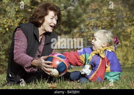 Grandmother playing ball with her granddaughter Stock Photo