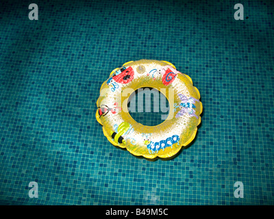 A childs inflated rubber ring floating in a swimming pool Stock Photo