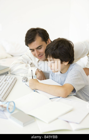 Father helping son with his homework Stock Photo