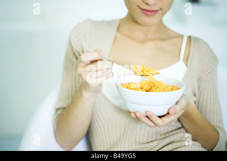 Woman holding bowl of cereal, cropped view Stock Photo