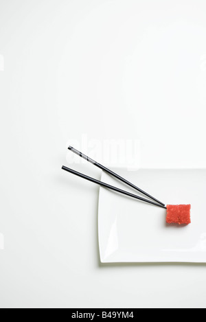 Maki sushi and chopsticks on sushi plate, overhead view Stock Photo