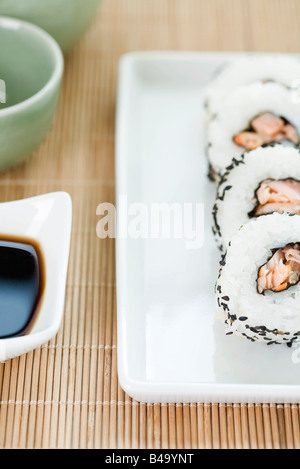 Cropped view of four pieces of maki sushi with soy sauce Stock Photo